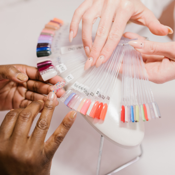 Two individuals reviewing polish colors