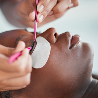 Woman receiving an eyelash extensions service